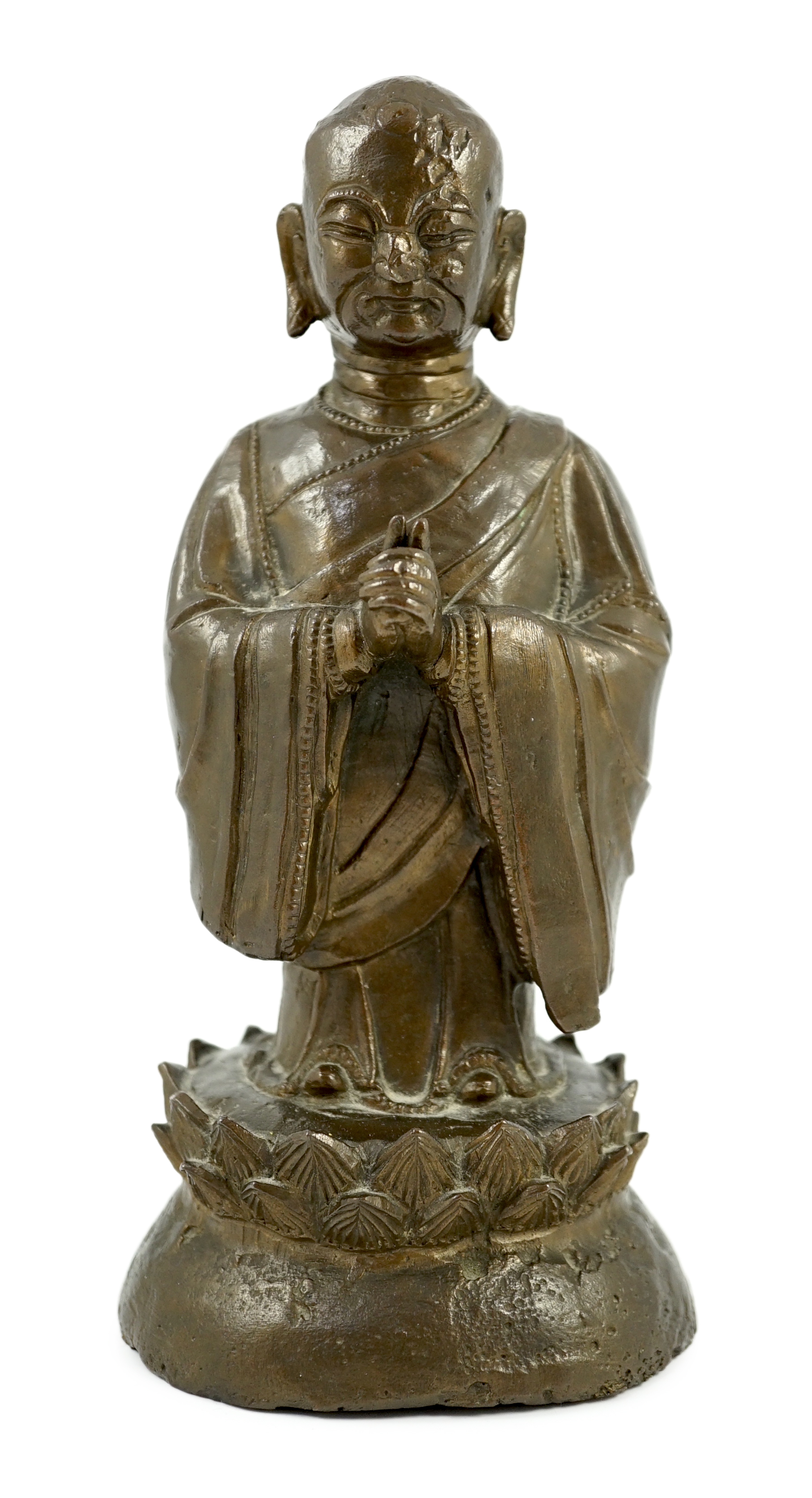 A Chinese bronze figure of a standing luohan, late Ming dynasty, some dents